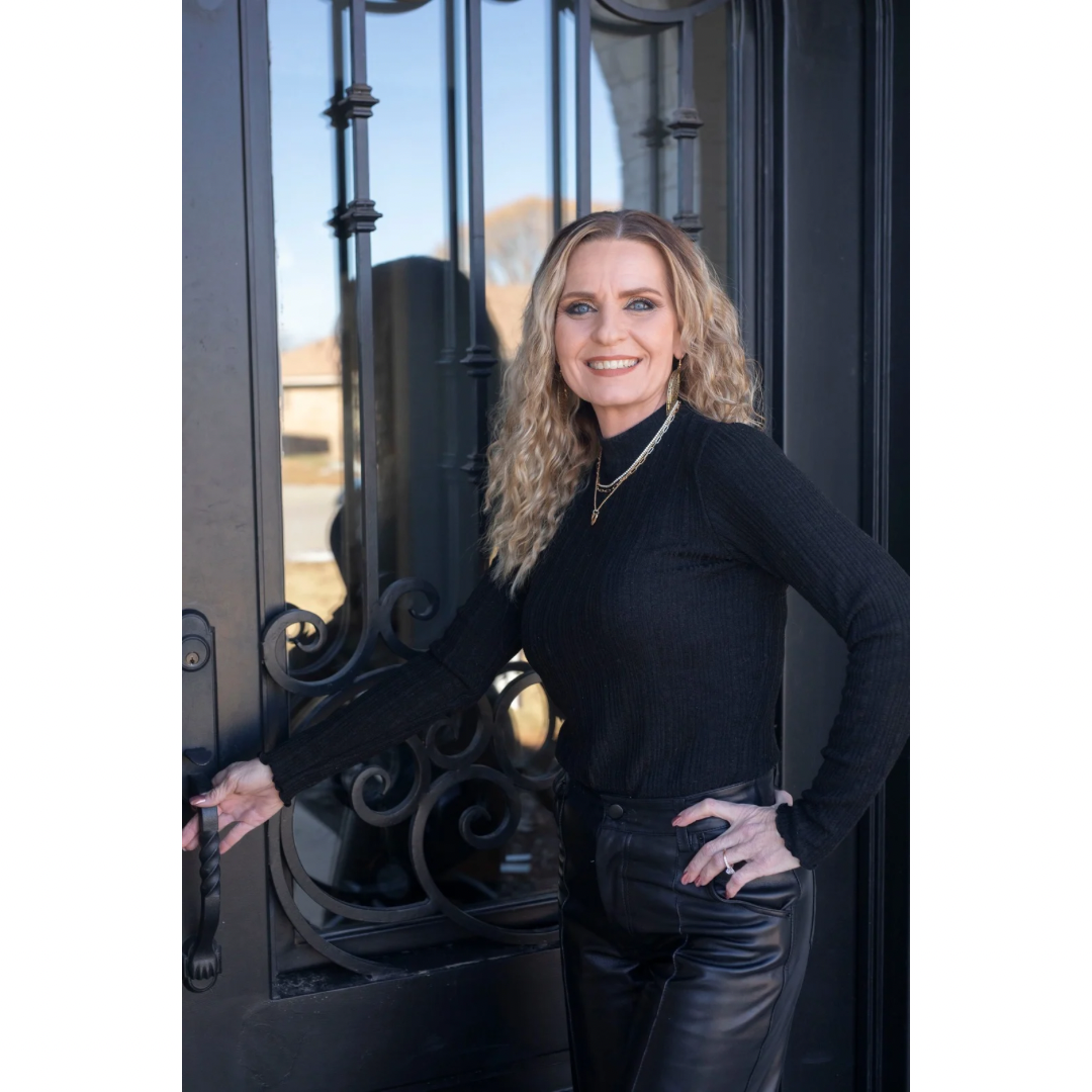 Candi McCormick associate at RE/MAX Hometown wearing a black mesh shirt