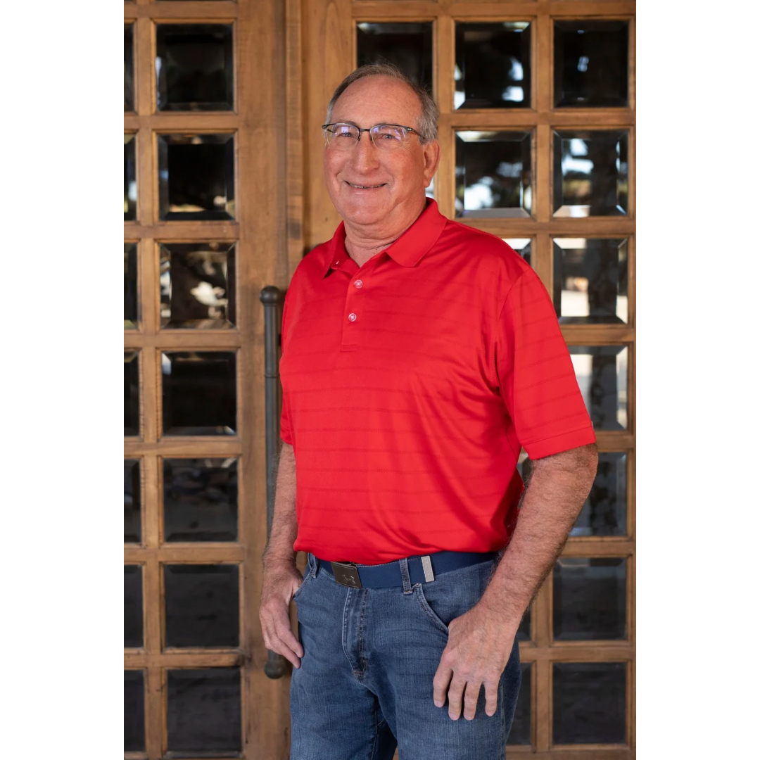 Dennis Edmondson, wearing a blue striped sweater, broker associate at RE/MAX Hometown in Pampa, TX